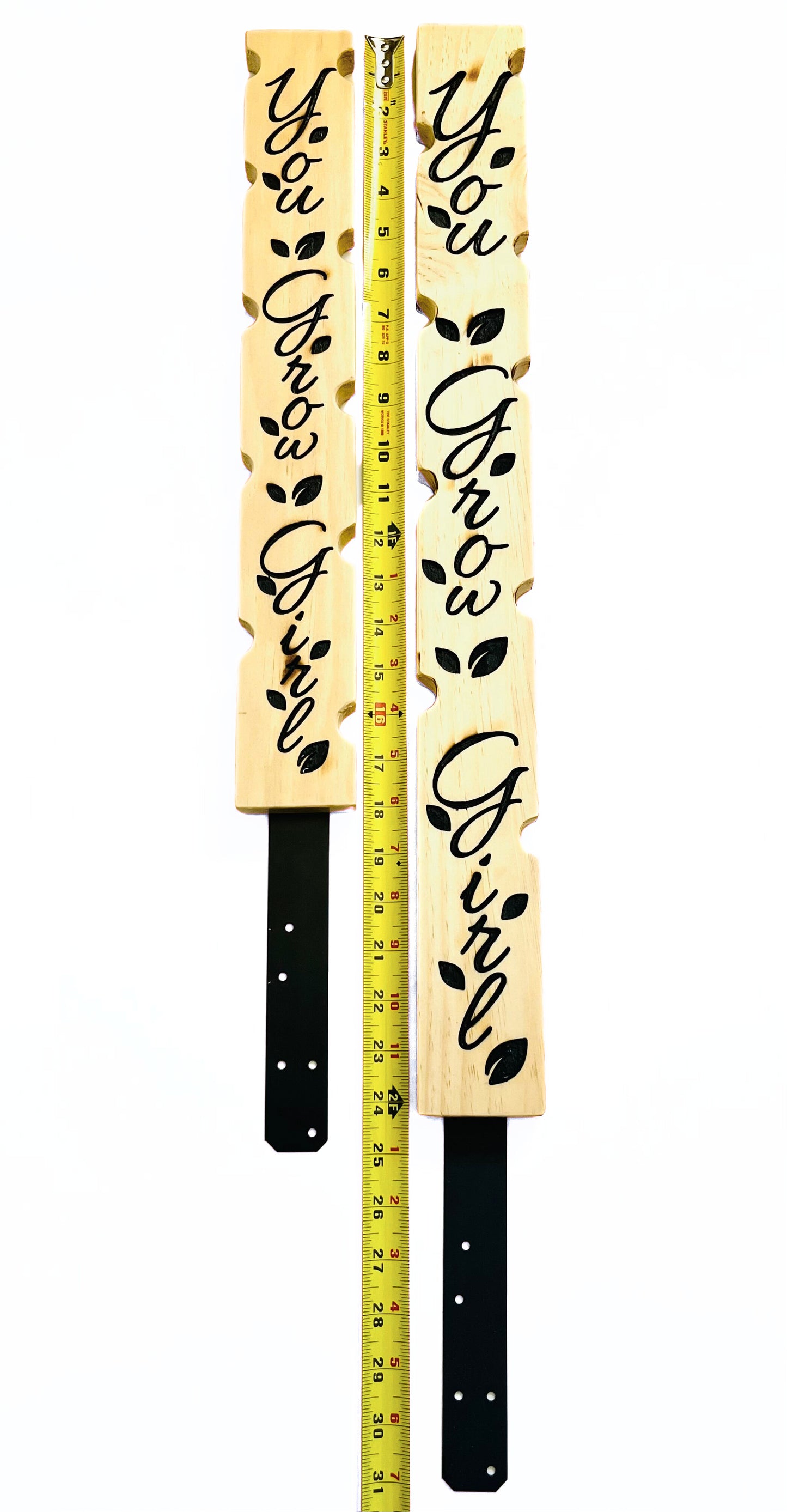 Carved wooden plant stakes with galvanized steel plate attached at the bottom